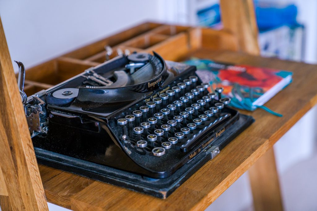 A typewriter on a desk ready to write a tourism blog post