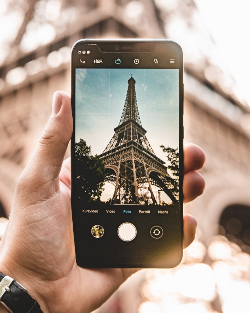 Tour guide takes photo of Eiffel Tower to post on social media 