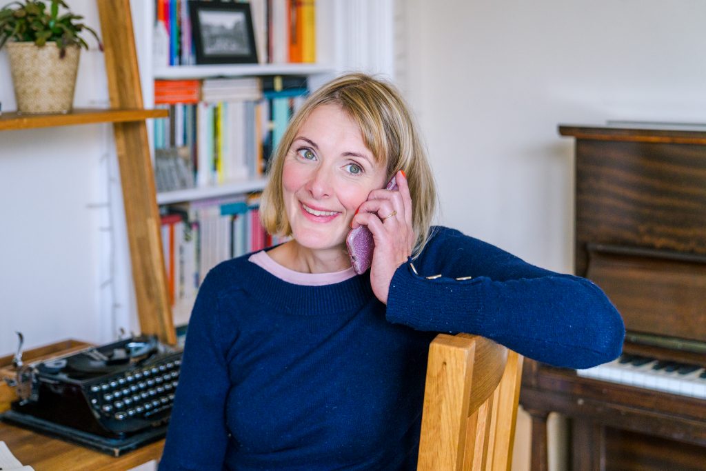 Genevieve on phone discussing copywriting services with potential travel business client