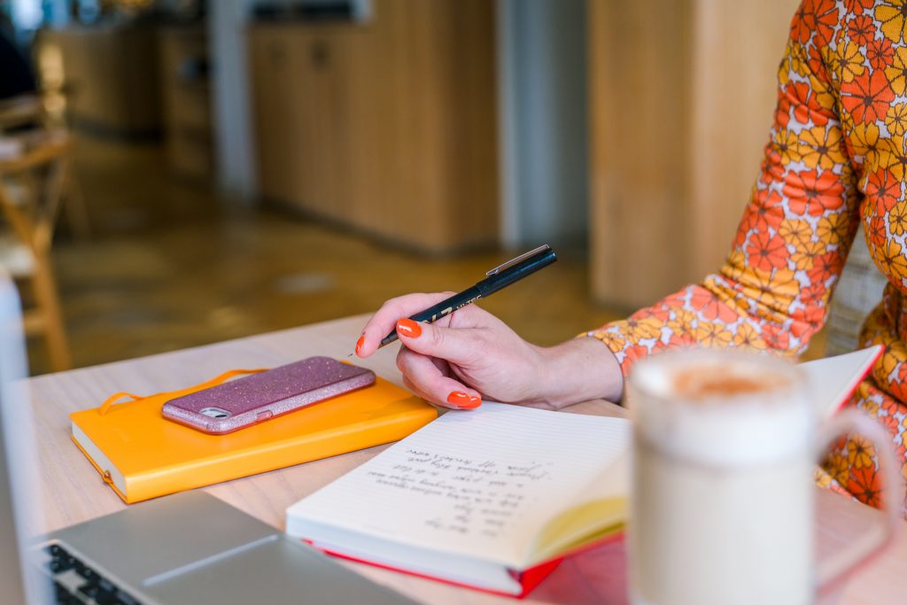 Shetland copywriter, Genevieve White, writing emails for local tourism businesses in a Shetland cafe.