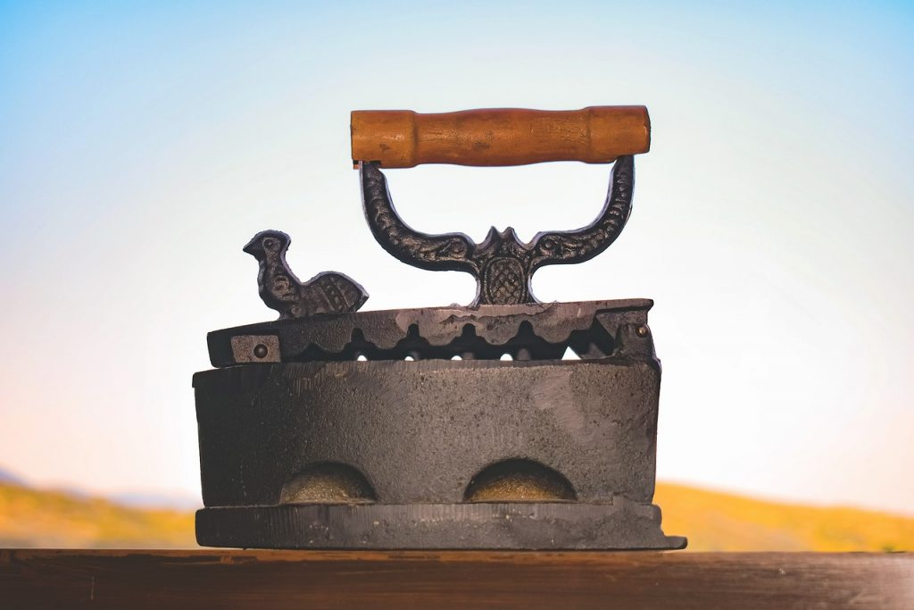 Vintage cast iron with wooden handle symbolising how AI writing flattens authentic voice into generic corporate-speak