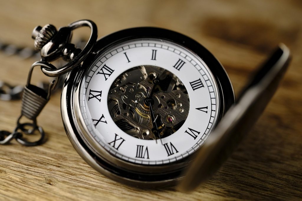 Vintage pocket watch on wooden surface illustrating the cost of waiting to start email marketing for tourism businesses
