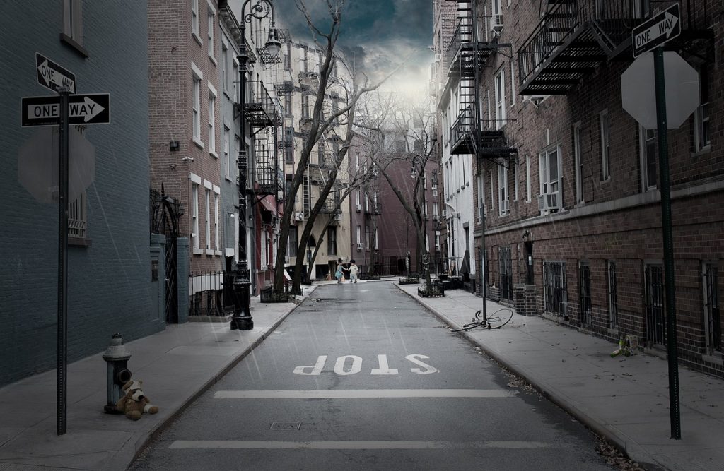 Urban street with STOP painted on road and one-way signs - what's stopping you from starting email marketing for your tourism business